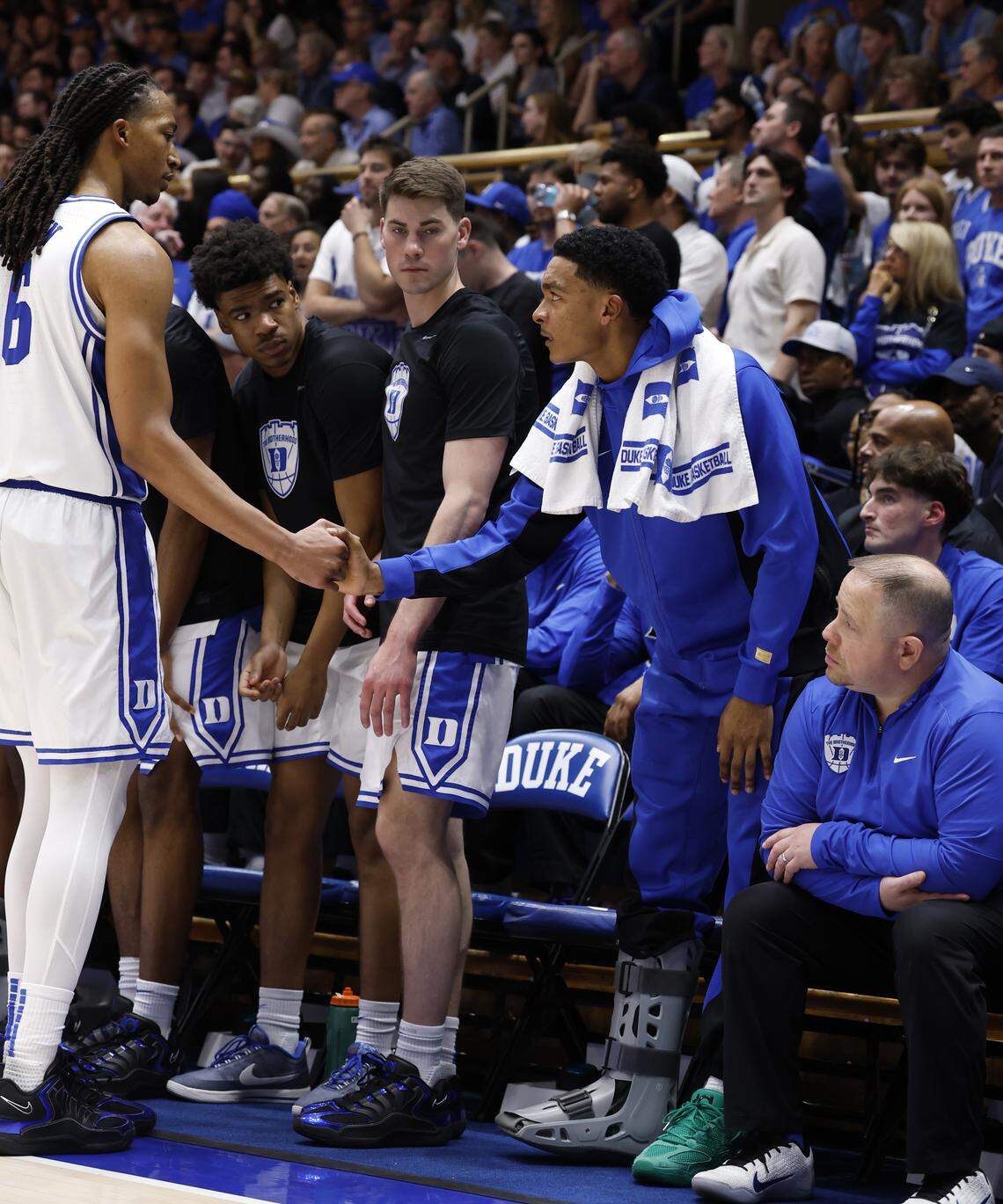 Duke’s Caleb Foster greets Maliq Brown (6) as he comes off the floor during the second half of Duke’s 76-61 victory over UNC at Cameron Indoor Stadium in Durham, N.C., Saturday, March 7, 2026.