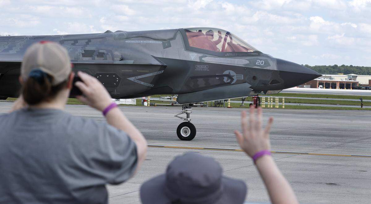 Spectators wave to a passing F-35B before its demonstration flight during the MCAS Cherry Point Air Show in Havelock, N.C., Sunday, May 10, 2026.