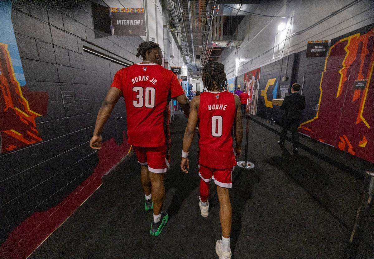 N.C. State’s D.J. Burns Jr. (30) and D.J. Horne (0) walk back to their locker room following their loss to Purdue in the NCAA Final Four National Semifinal game against Purdue on Saturday, April 6, 2024 at State Farm Stadium in Glendale, AZ.