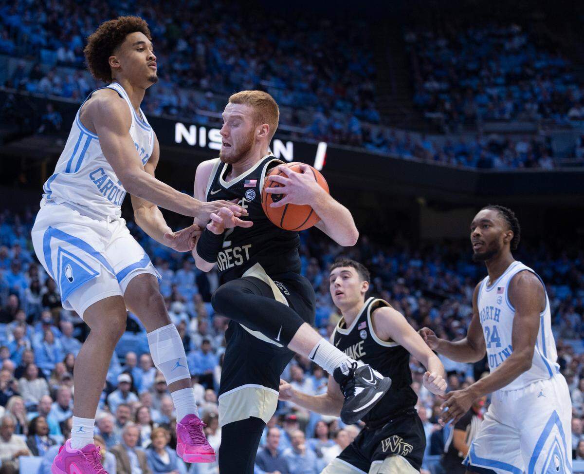 North Carolina’s Seth Trimble (7) and Wake Forest’s Cameron Hildreth (2) battle for a rebound in the first half on Monday, January 22, 2024 at the Smith Center in Chapel Hill, N.C.