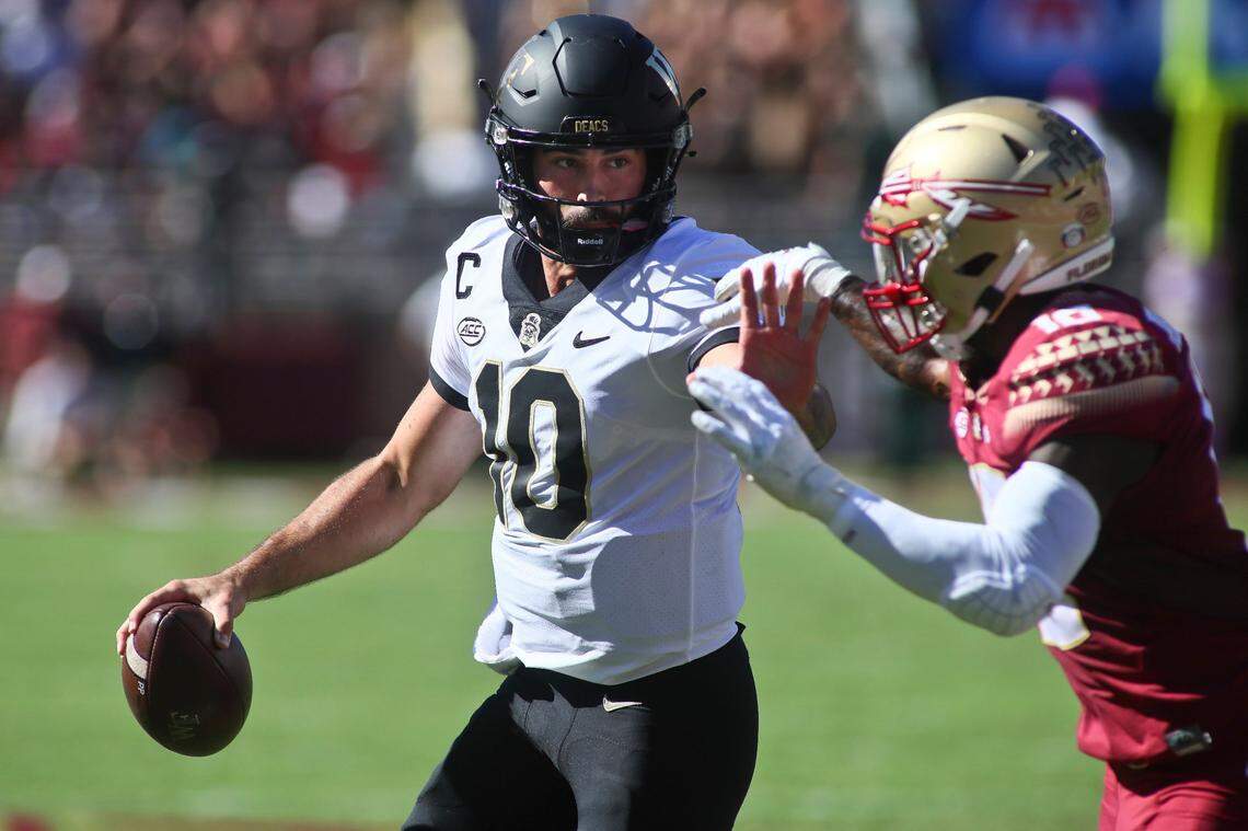 Wake Forest quarterback Sam Hartman (10) tries to stiff arm Florida State defensive back Jammie Robinson (10) in the first half of an NCAA college football game against Florida State Saturday, Oct. 1, 2022, in Tallahassee.