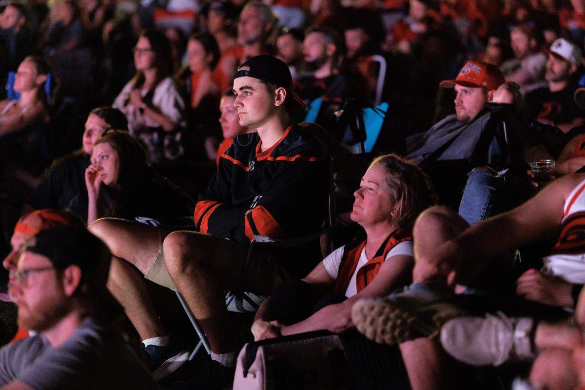 Carolina Hurricanes fans react while watching the second period during a watch party for Game 2 of the Stanley Cup Final against the Vegas Golden Knights in Moore Square on Thursday, June 4, 2026, in Raleigh, N.C.