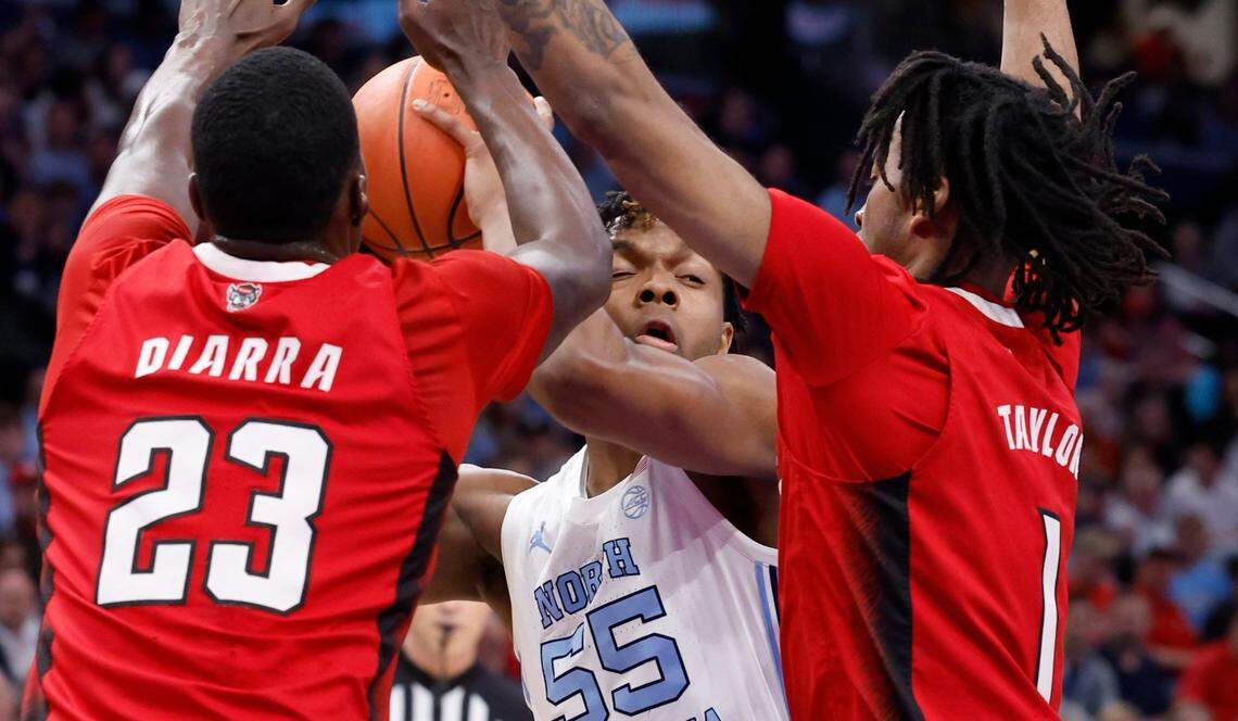 N.C. State’s Mohamed Diarra (23) and Jayden Taylor (1) defend North Carolina’s Harrison Ingram (55) during the first half of N.C. State’s game against UNC in the championship game of the 2024 ACC Men’s Basketball Tournament at Capital One Arena in Washington, D.C., Saturday, March 16, 2024.