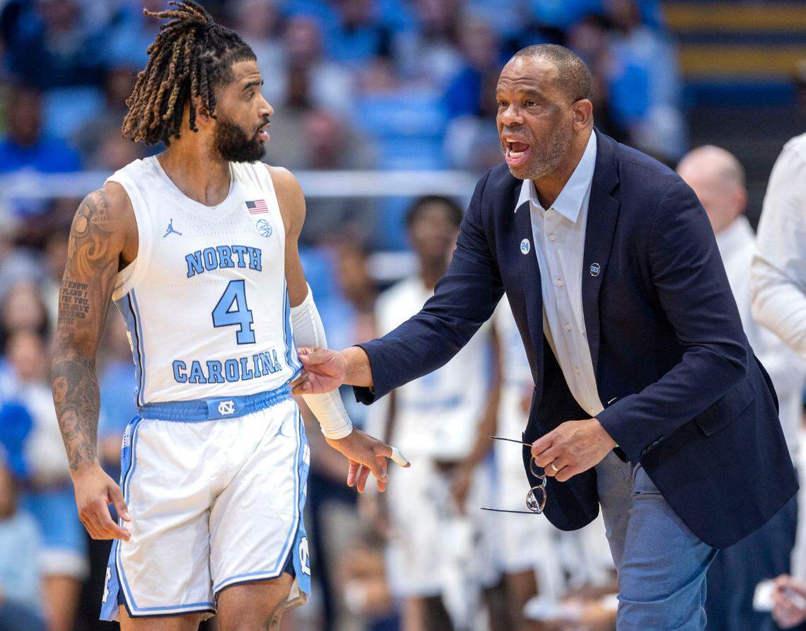 North Carolina coach Hubert Davis confers with guard R.J. Davis (4) during the first half against Johnson C. Smith on Sunday, October 27, 2024 at the Smith Center in Chapel Hill, N.C.