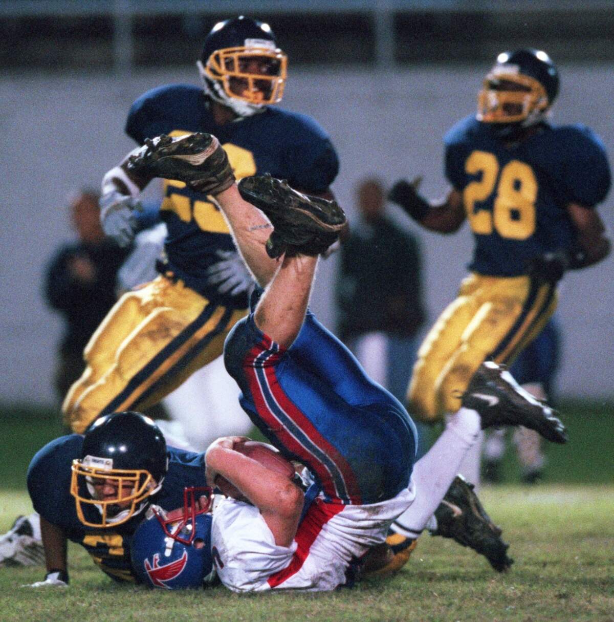Northern Durham's Josh Gattis (24) sacks Jordan quaterback Brent Blaylock (13) in the second quarter of play on Oct. 22, 1999 in Durham County Stadium. Northern's Zamar Gates (23) and A. J. Davis (28) helped apply pressure to the quaterback.