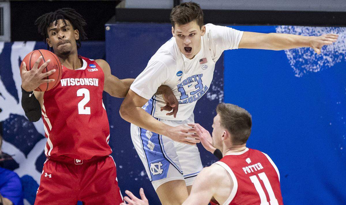 Wisconsin’s Aleem Ford (2) grabs a rebound next to North Carolina’s Walker Kessler (13) during the first half of a first-round game in the NCAA men’s college basketball tournament Friday, March 19, 2021, at Mackey Arena in West Lafayette, Ind. 