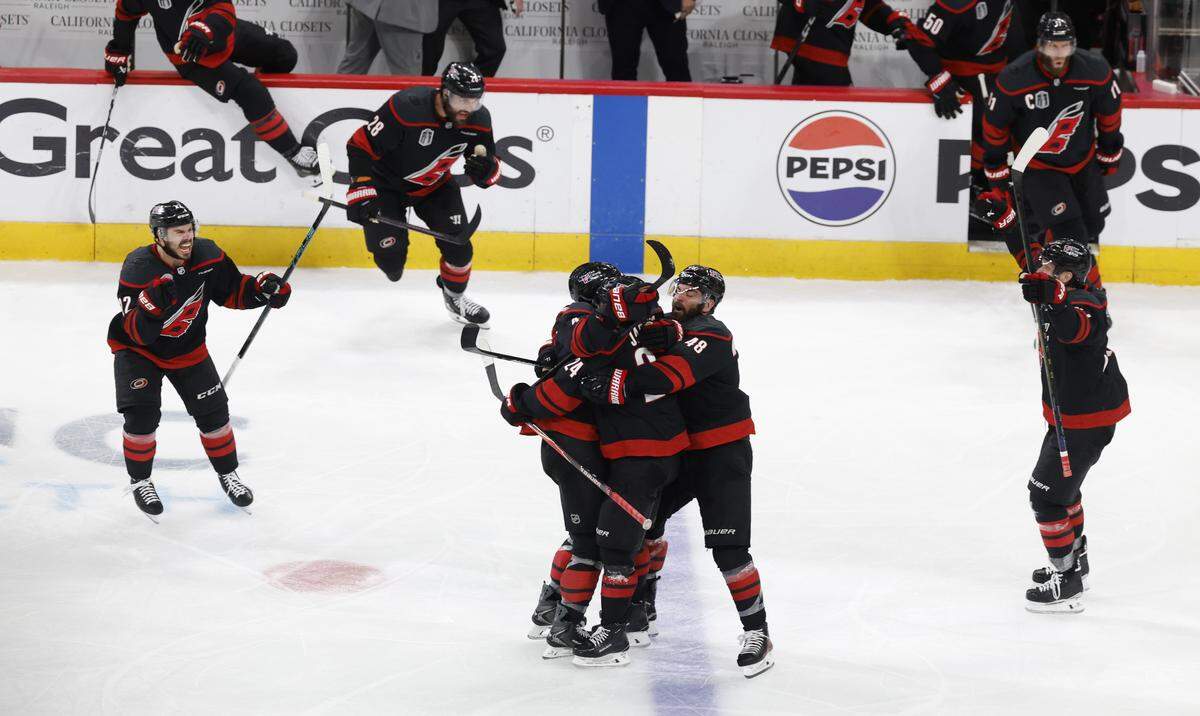 Players mob Carolina's Seth Jarvis after he scored in overtime of the Hurricanes’ 4-3 victory over the Golden Knights in the second game of the Stanley Cup Final at the Lenovo Center in Raleigh, N.C., Thursday, June 4, 2026.