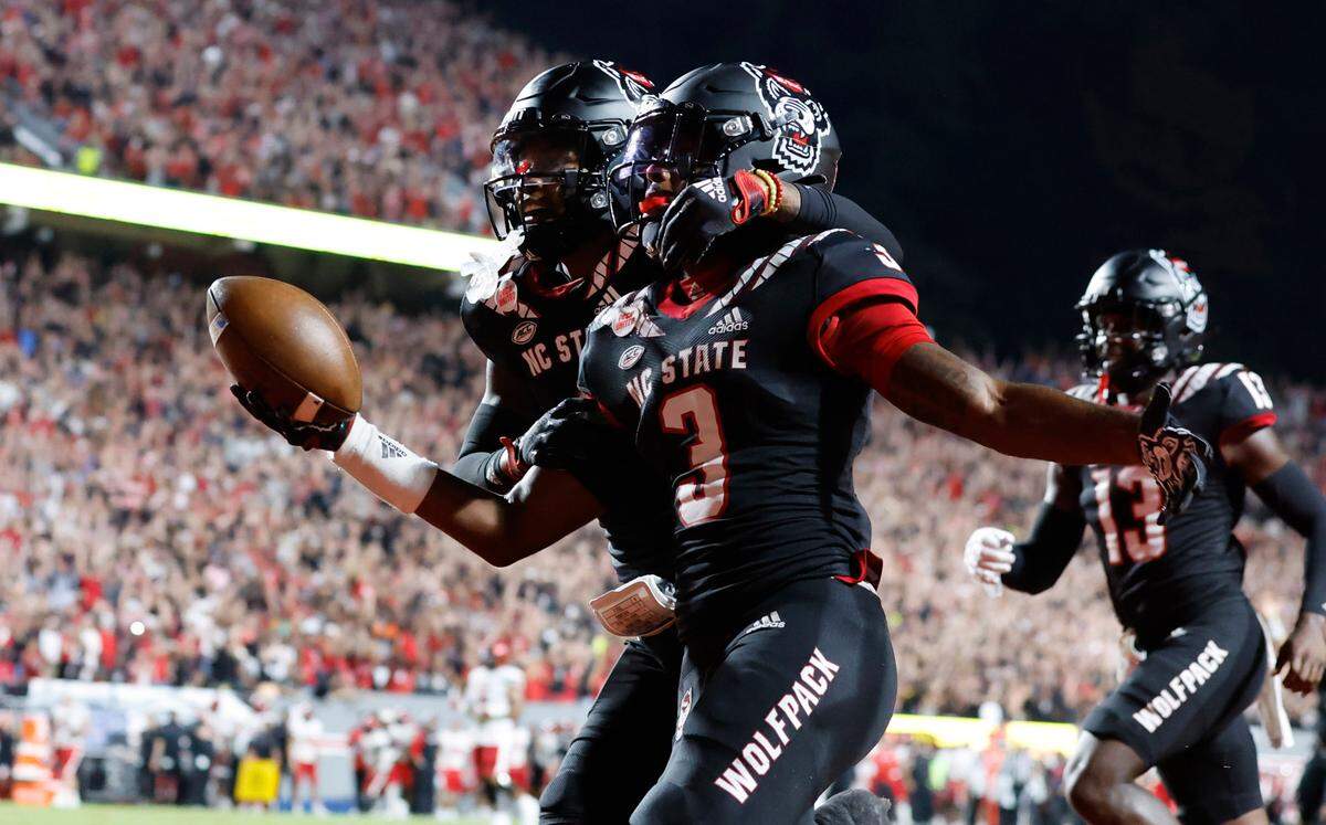 N.C. State’s Cyrus Fagan (4) celebrates with Aydan White (3) after White returned his interception 84-yards for a touchdown during the first half of N.C. State’s game against Texas Tech at Carter-Finley Stadium in Raleigh, N.C., Saturday, Sept. 17, 2022.