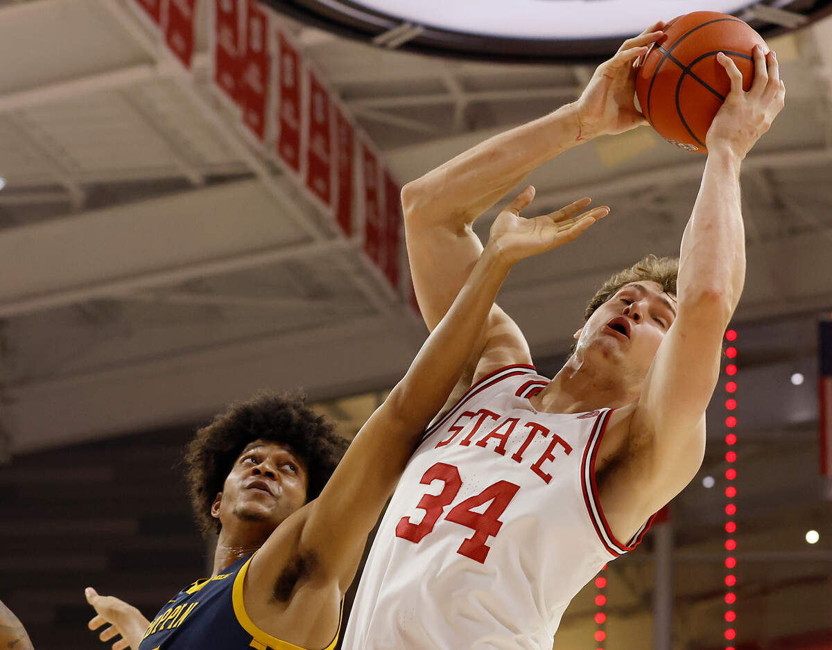 N.C. State’s Ben Middlebrooks grabs a rebound away from Coppin State’s Peter Oduro during the first half of the Wolfpack’s 66-56 win on Tuesday, Dec. 10, 2024, at Reynolds Coliseum in Raleigh, N.C.