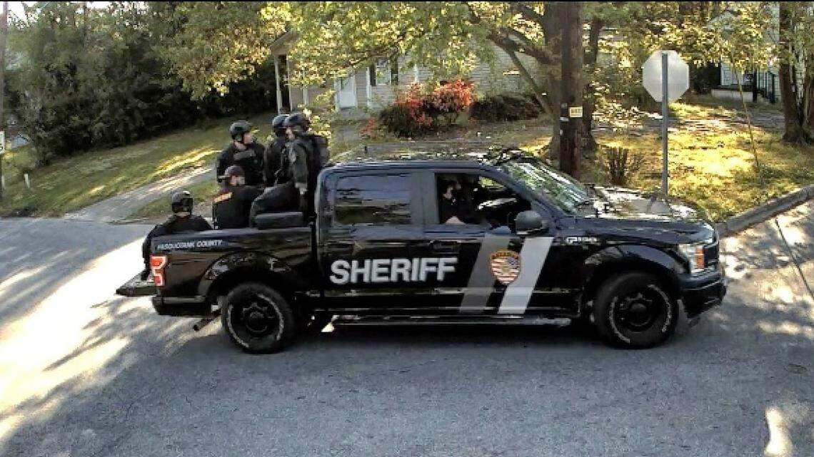 A screenshot from a camera operated by Elizabeth City government shows Pasquotank County sheriff’s deputies arriving arrived in tactical gear to serve search and arrest warrants related to felony drug charges on Andrew Brown Jr. April 21. Brown was shot and killed by deputies during the incident. Sheriff Tommy Wooten said a preliminary investigation and review of body camera footage shows that three deputies fired their weapons and will remain on leave until investigations are complete. Four deputies did not fire their weapons, Wooten said, and are now back on active duty.