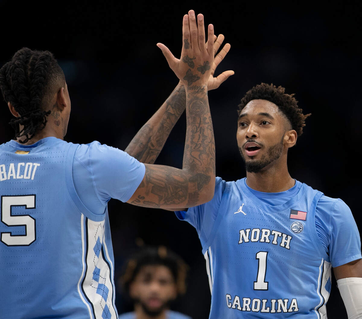 North Carolina’s Armando Bacot (5) and Leaky Black (1) celebrate their 80-76 victory over Michigan on Wednesday, December 21, 2022 at the Spectrum Center in Charlotte, N.C.