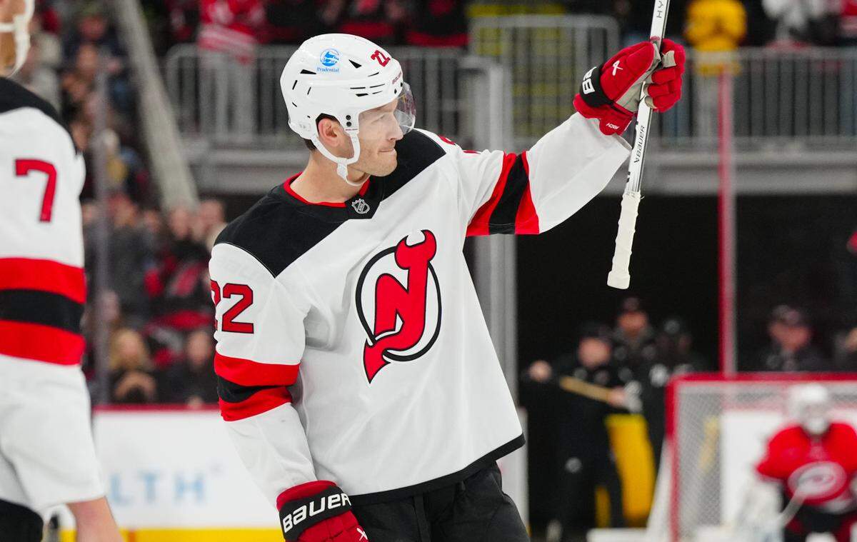 New Jersey Devils defenseman Brett Pesce (22) waves to the Carolina Hurricanes crowd during the first period at Lenovo Center.