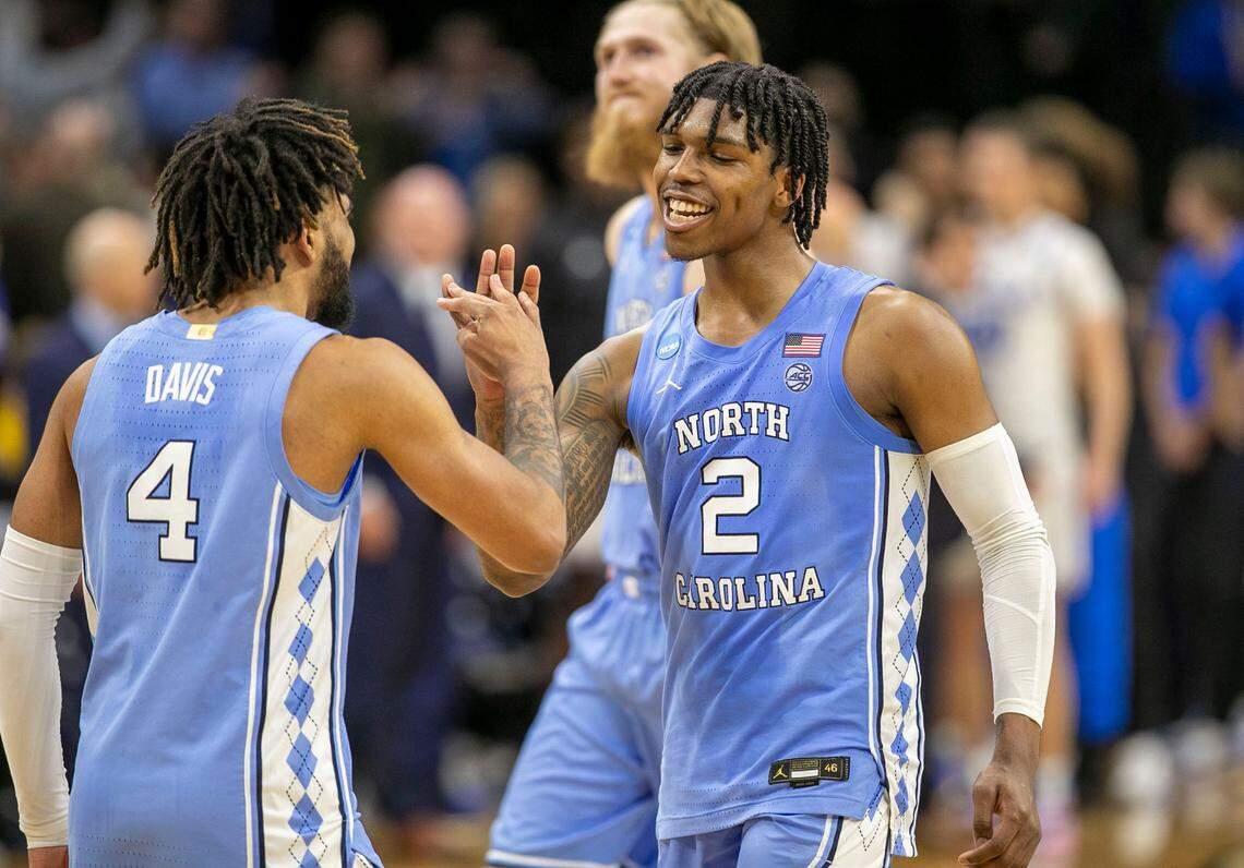 North Carolina’s Caleb Love (2) and R.J. Davis (4) react as they secure the Tar Heels’ 73-66 victory over UCLA on Friday, March 25, 2022 during the NCAA East Regional semi-final at Wells Fargo Center in Philadelphia, Pa.