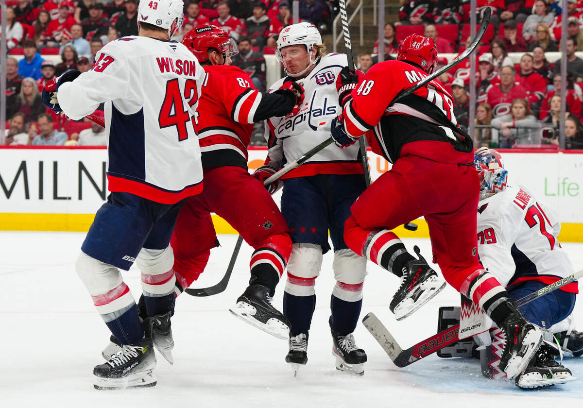 Washington Capitals defenseman Rasmus Sandin (38) Carolina Hurricanes center Jesperi Kotkaniemi (82) and left wing Jordan Martinook (48) watch a shot during the third period at Lenovo Center.