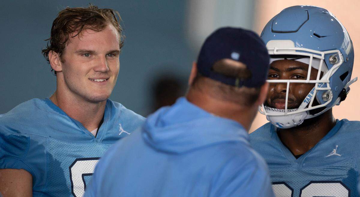 North Carolina tight ends John Copenhaver (81) and Kamari Morales (88) listen to to coach Freddie Kitchens during their first day of practice on Wednesday, August 2, 2023 in Chapel Hill, N.C.