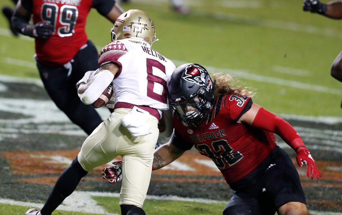 N.C. State linebacker Drake Thomas (32) stops Florida State wide receiver Keyshawn Helton (6) during the first half of N.C. State’s game against Florida State at Carter-Finley Stadium in Raleigh, N.C., Saturday, Nov. 14, 2020.