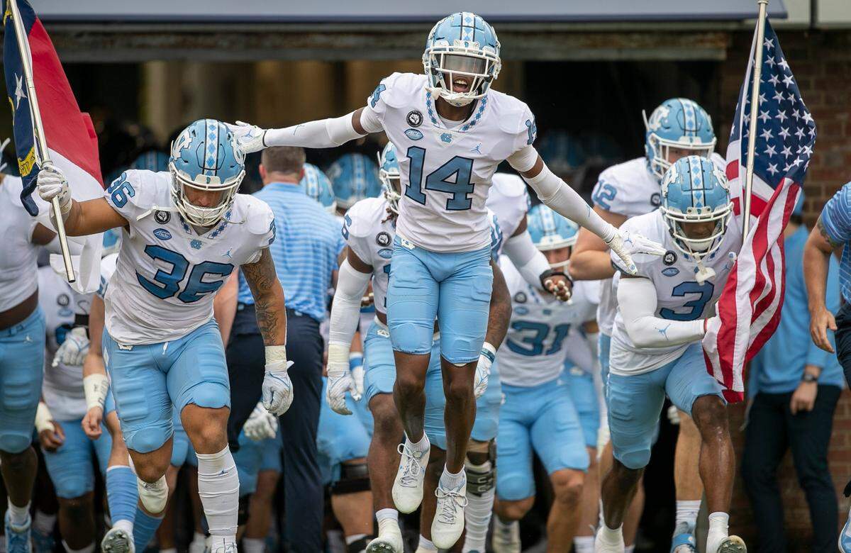 Dante Balfour (14) and the North Carolina Tar Heels enter Scott Stadium for their game against Virginia on Saturday, November 5, 2022 at Scott Stadium in Charlottesville, Va.