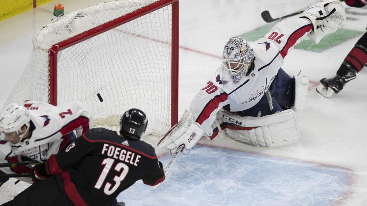 Carolina Hurricanes’ Warren Foegele (13) scores on Washington Capitals’ goalie Braden Holtby (70) during the first period in game four of the first round Stanley Cup series game on Thursday, April 18, 2019 at the PNC Arena in Raleigh, N.C.