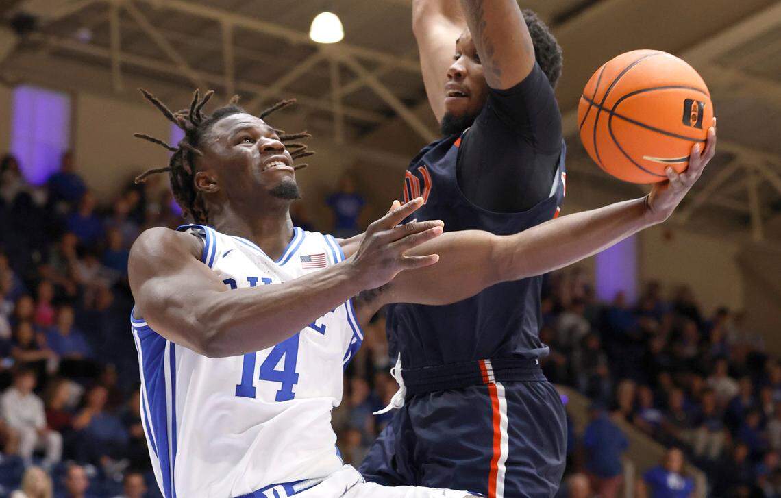 Duke’s Sion James (14) shoots as Lincoln’s Peter Sorber (25) defends during the second half of Duke’s 107-56 exhibition victory over Lincoln (Pa) University at Cameron Indoor Stadium in Durham, N.C., Saturday, Oct. 19, 2024.