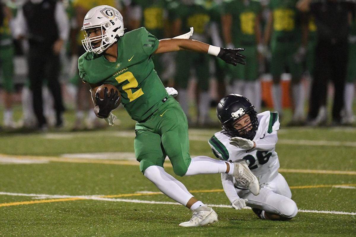 Cardinal Gibbons wide receiver Aiden Smalls (2) sprints for yardage ahead of Leesville Road's Max Short (26) during the  first half. The Cardinal Gibbons Crusaders and the Leesville Road Pride met in a conference football game in Raleigh, N.C. on October 27, 2023.