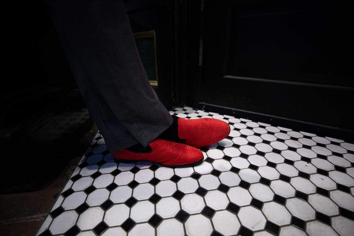 Carl Wells, a bartender at Hibernian Irish Pub & Restaurant, greets visitors with bright red shoes on the evening of Friday, July 2023.