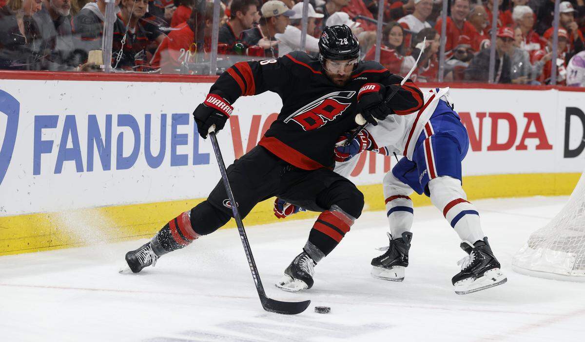 Carolina's William Carrier (28) works his way around Montréal's Lane Hutson (48) during the first period of the Hurricanes’ game against the Canadiens in game one of the Eastern Conference Finals at the Lenovo Center Thursday, May, 21, 2026.