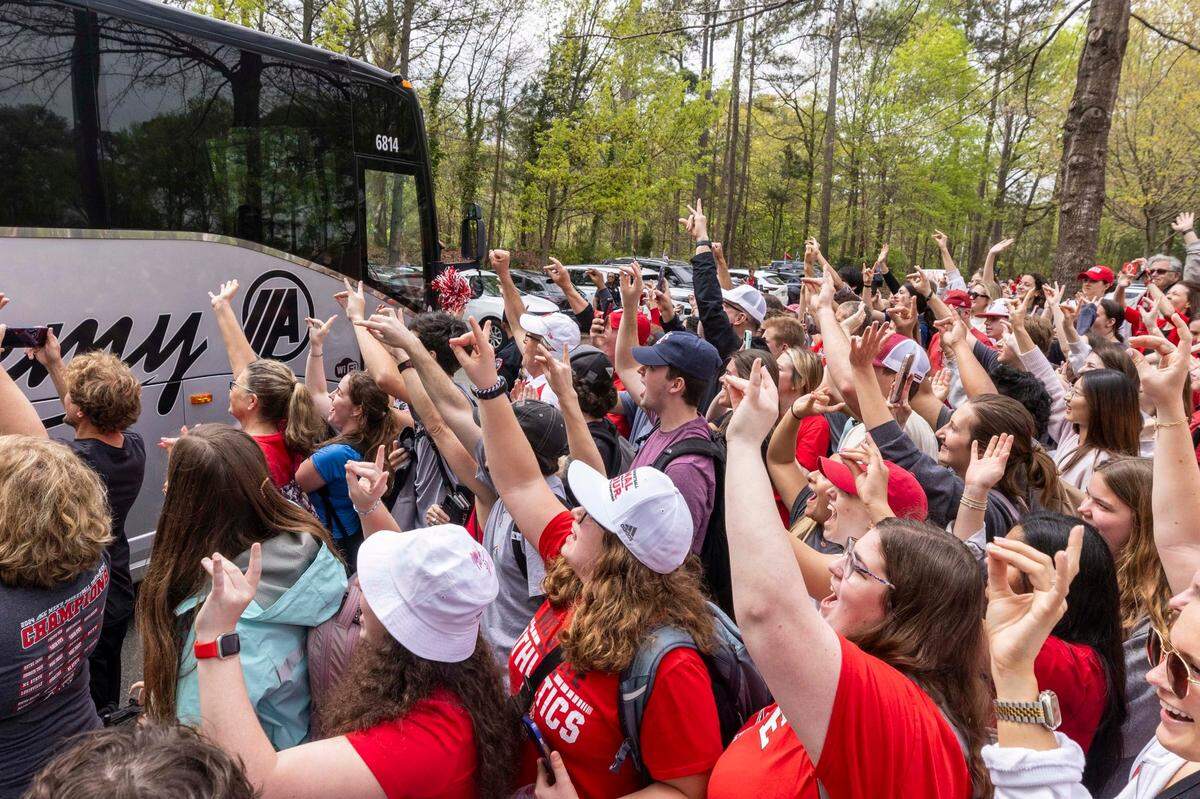 NC.State fans cheer as a bus carrying the men’s basketball team departs campus Wednesday, April 3, 2024. The team is headed to the Final Four for the first time since 1983.