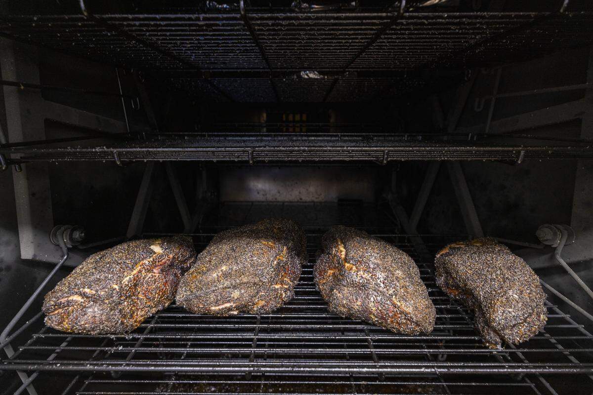 Texas-style brisket cooks at a low temperature for around 10 hours at Lawrence Barbecue.