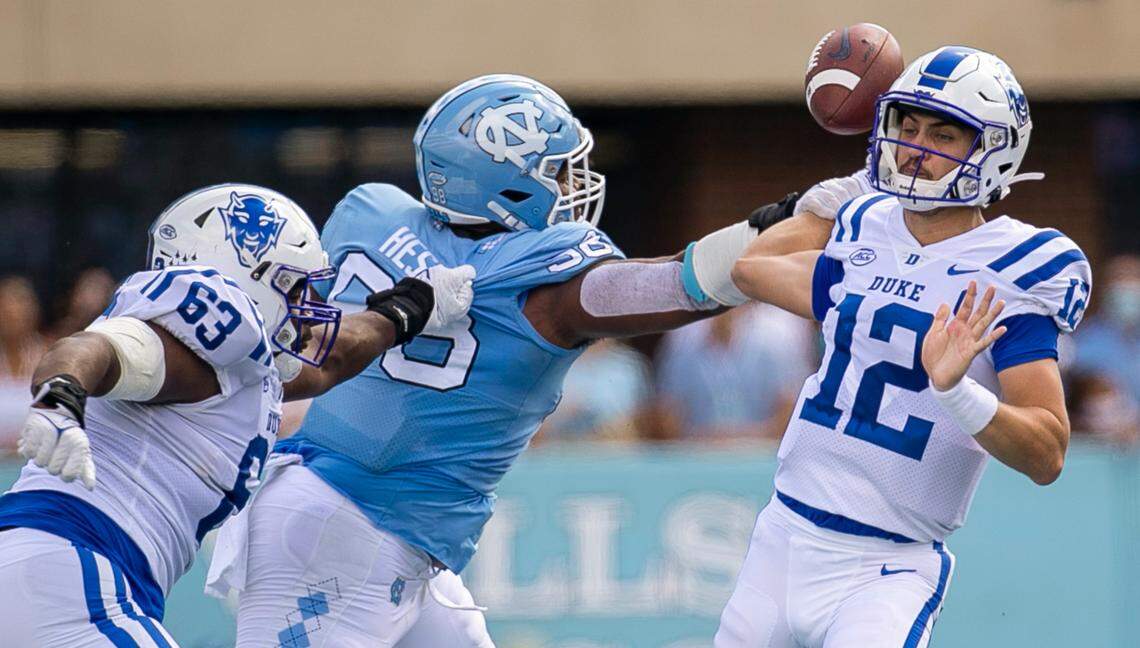 North Carolina’s Kevin Hester Jr. (98) forces Duke quarterback Gunnar Holmberg (12) to fumble in the second quarter on Saturday, October 2, 2021 at Kenan Stadium in Chapel Hill, N.C. North Carolina’s Trey Morrison returned the fumble for a touchdown.