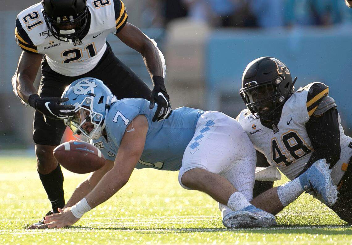 Appalachian State’s Ryan Huff (21) and Demetrius Taylor (48) sack North Carolina quarterback Sam Howell (7) for a loss of three yards and force a fumble which North Carolina recovered in the third quarter on Saturday, September 21, 2019 at Kenan Stadium in Chapel Hill, N.C.