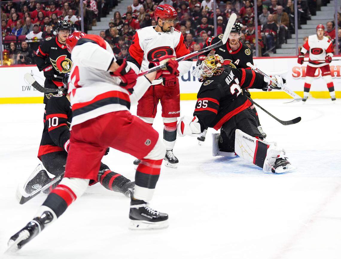 Goaltender Linus Ullmark of the Ottawa Senators stretches to make a save against Andrei Svechnikov of the Carolina Hurricanes as Jordan Spence (10) of the Ottawa Senators blocks the shot during the first period in Game 3 of the first round of the 2026 Stanley Cup playoffs at Canadian Tire Centre on April 23, 2026, in Ottawa, Canada.
