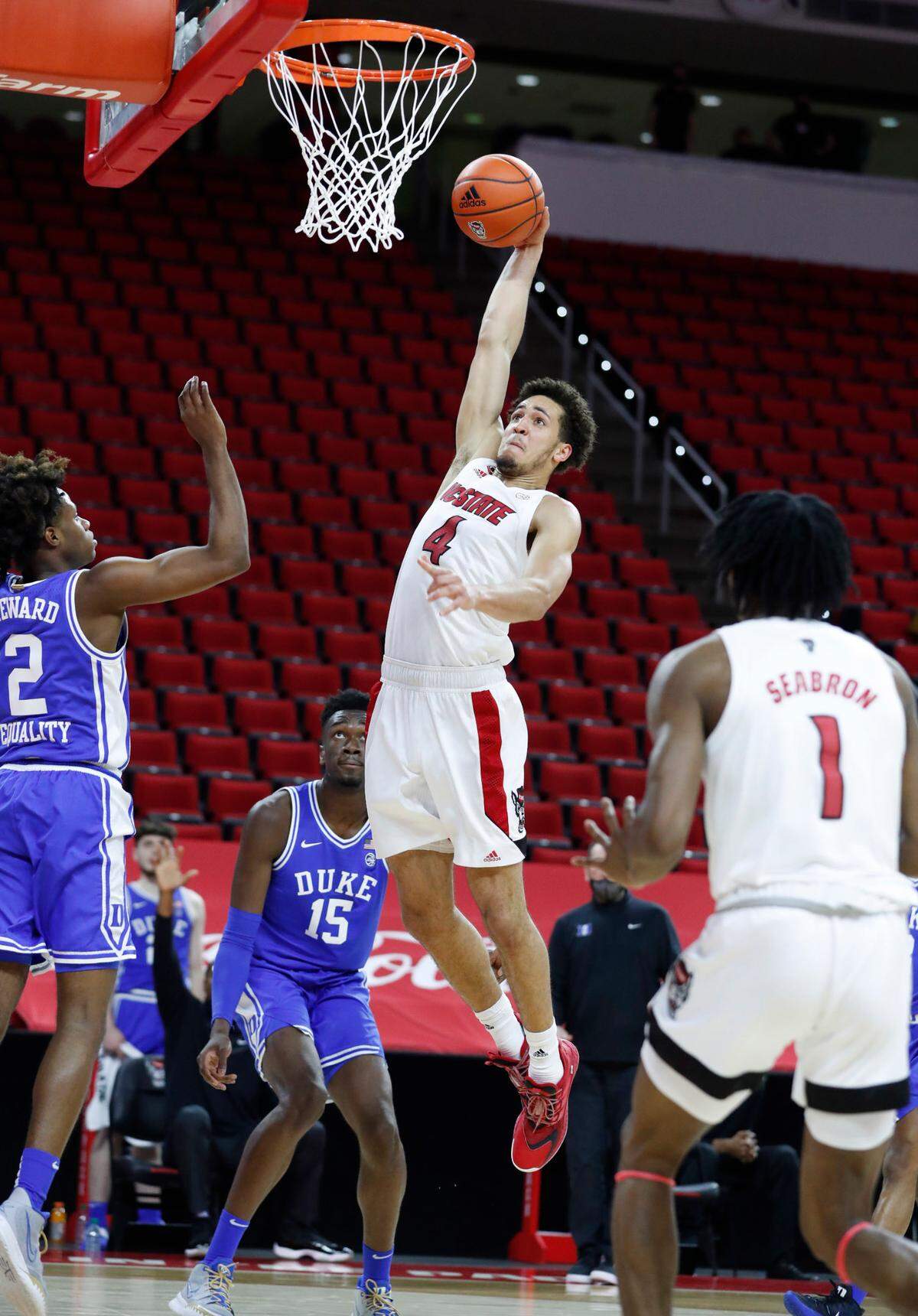 N.C. State’s Jericole Hellems (4) heads to slam in two during the first half of N.C. State’s game against Duke at PNC Arena in Raleigh, N.C., Saturday, February 13, 2021.