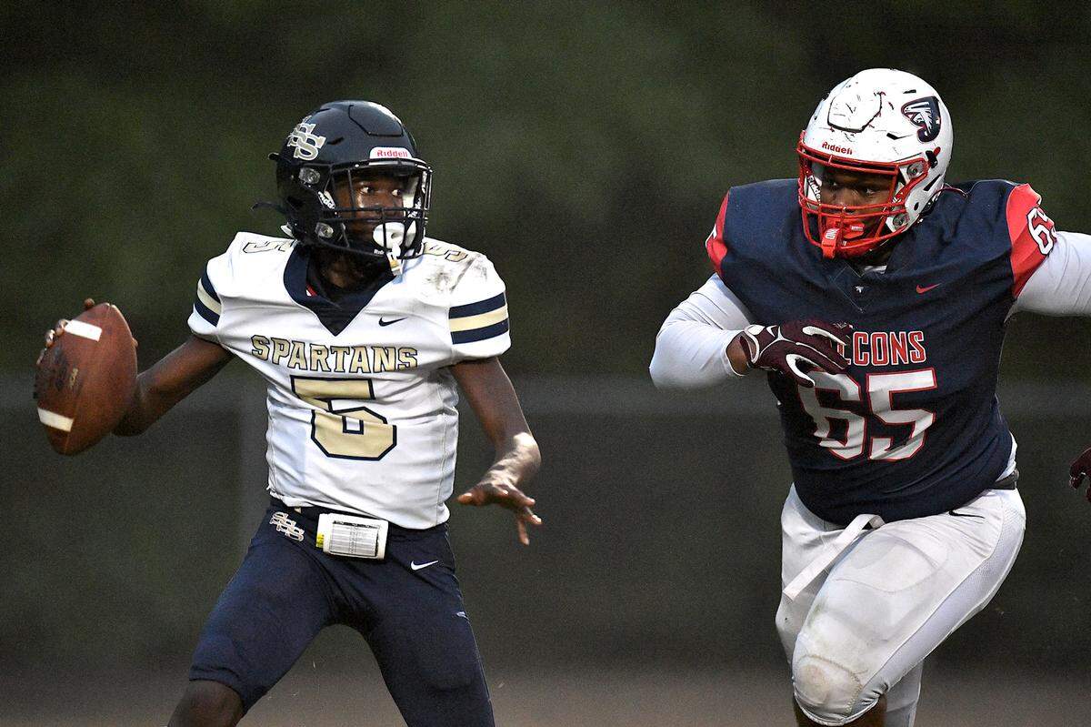 Jordan’s Noah Clark (65) pressure’s Smithfield-Selma quarterback Noah Jeter (5) during the first half. The Durham Jordan Falcons and the Smithfield-Selma Spartans met in a football game in Durham, N.C. on September 13, 2024.