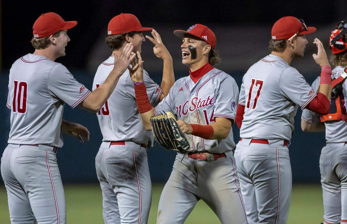 N.C. State’s Ty Head (14) celebrates with his teammates following the Wolfpack’s 8-5 victory over North Carolina on Friday, May 9, 2025 at Boshamer Stadium in Chapel Hill, N.C.