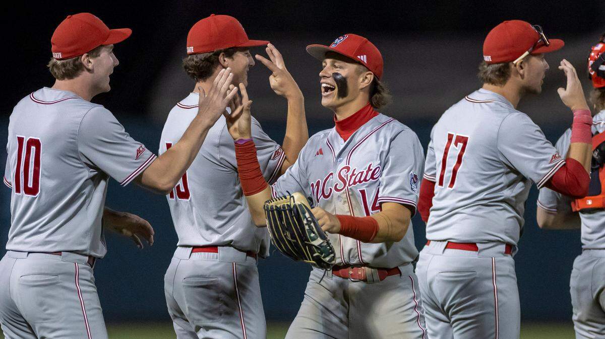 N.C. State’s Ty Head (14) celebrates with his teammates following the Wolfpack’s 8-5 victory over North Carolina on Friday, May 9, 2025 at Boshamer Stadium in Chapel Hill, N.C.
