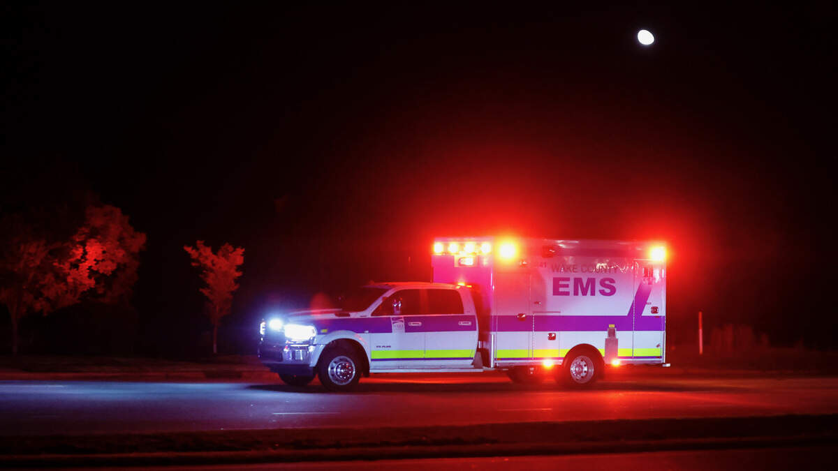 An ambulance that was escorted by two police officers on motorcycles rushes down New Bern Avenue shortly before 10 p.m. in after 5 people were shot and killed in the Hedingham Neighborhood and Nuese River Trail area in Raleigh Thursday, Oct. 13, 2022.