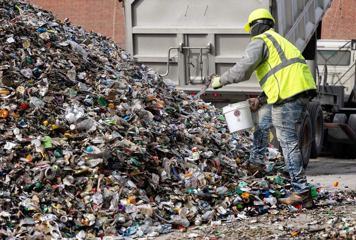 Quality Technician Keydrick Parker examines a delivery of Inbound 3 Mix at Strategic Materials, Inc. in Wilson, N.C. on Wednesday, Jan. 18, 2023. After receiving a delivery from recycling programs, the plant screens, crushes, and sorts glass into furnace-ready material called “cullet,” which is then used to make new products.