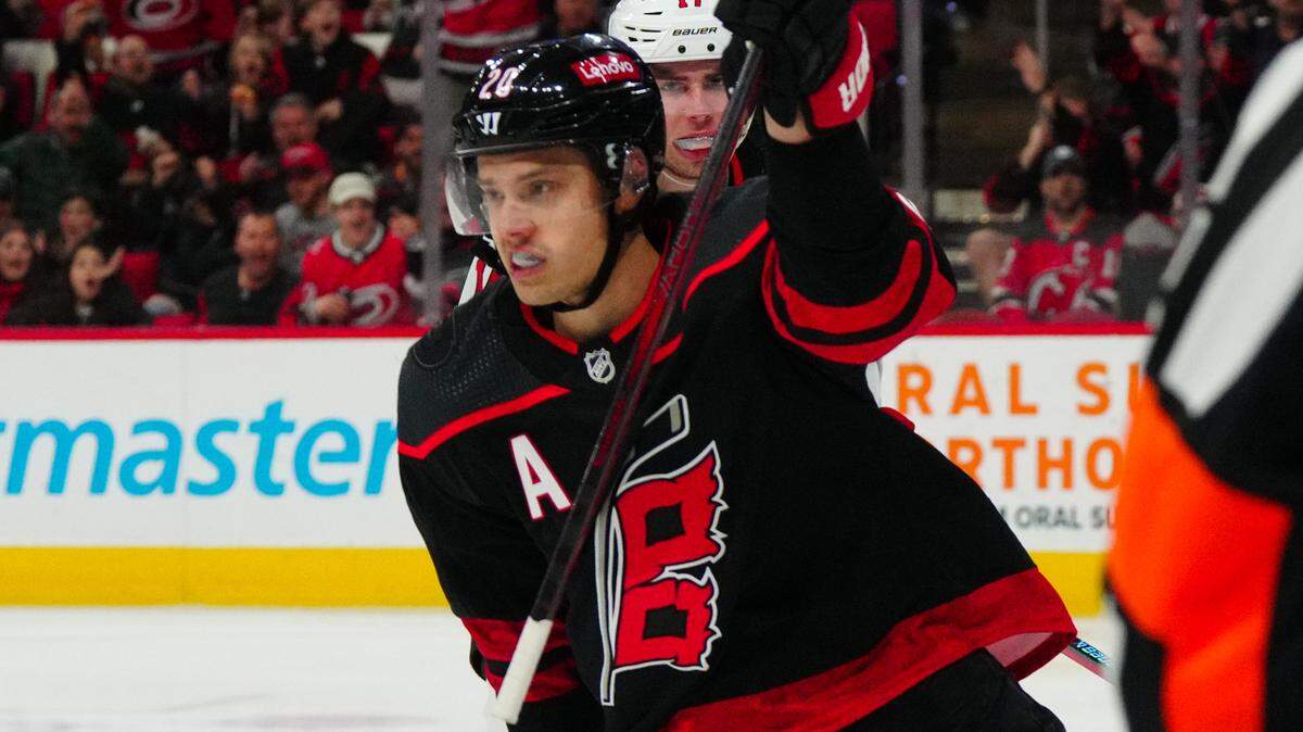 Jan 25, 2024; Raleigh, North Carolina, USA; Carolina Hurricanes center Sebastian Aho (20) scores a goal against the New Jersey Devils during the first period at PNC Arena. Mandatory Credit: James Guillory-USA TODAY Sports