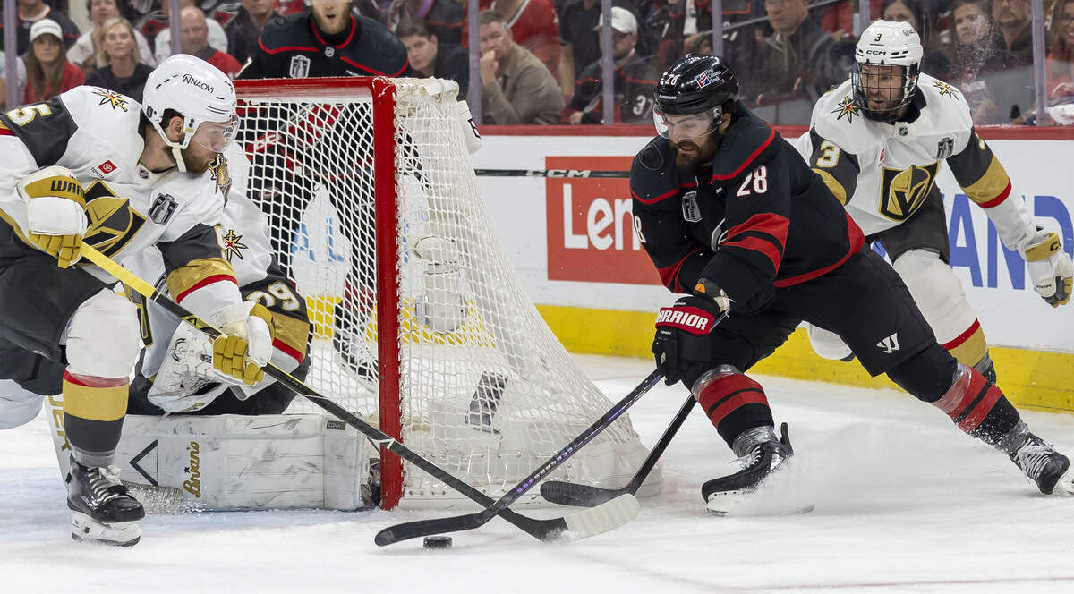 Carolina Hurricanes left wing William Carrier (28) moves the puck around the net against Vegas defenseman Jeremy Lauzon (5) and goalie Vegas goalie Carter Hart (79) in the third period during Game 5 of the Stanley Cup Final against Vegas, on Thursday, June 11, 2026 at Lenovo Center in Raleigh, N.C.