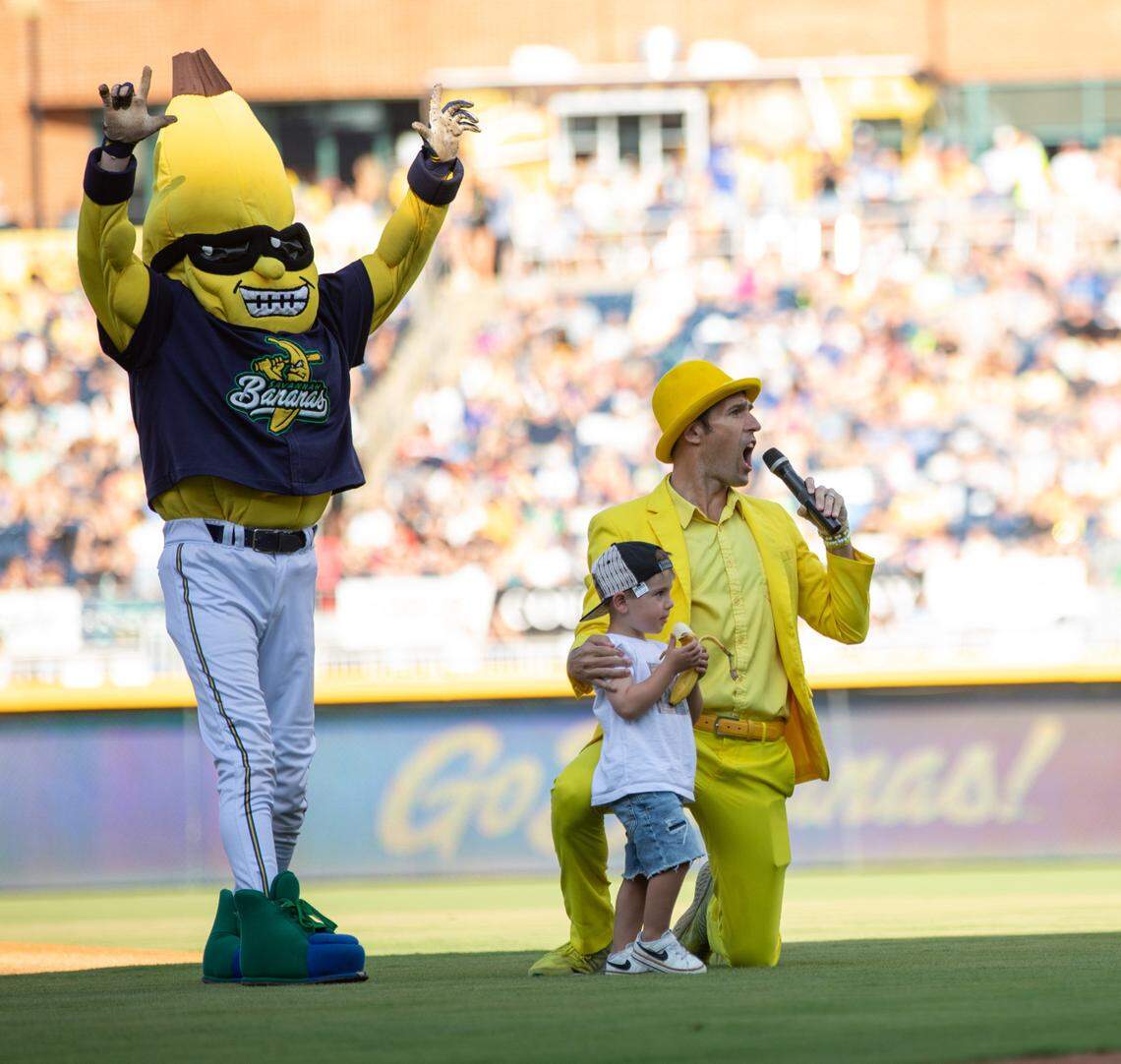 A young fan opens the Savannah Bananas game with the ceremonial “first peel” at Durham Bulls Athletic Park in Durham, N.C. on Friday, July 14, 2023.