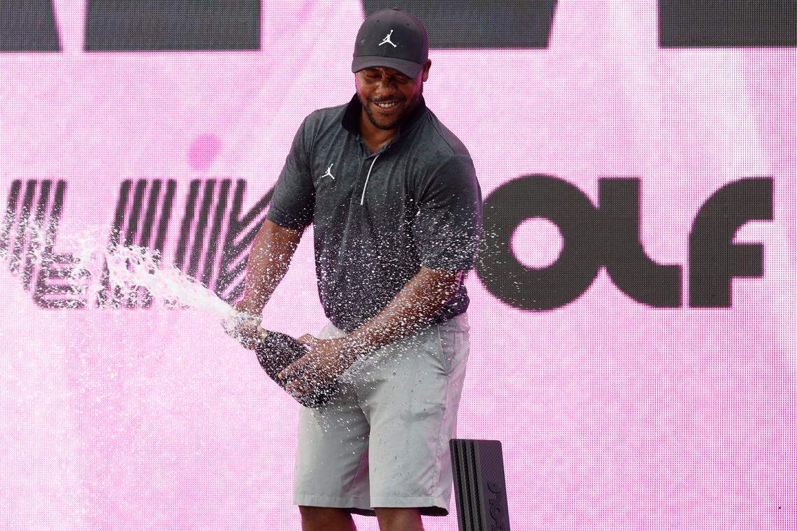 Harold Varner III celebrates on the podium after winning the individual championship of LIV Golf Washington, D.C. golf tournament at Trump National.