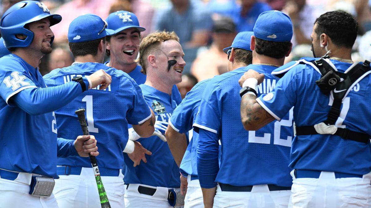 Kentucky Wildcats center fielder Nolan McCarthy (19) celebrates with the team after hitting a home run against the N.C. State Wolfpack during the fourth inning at Charles Schwab Field in Omaha, Nebraska.