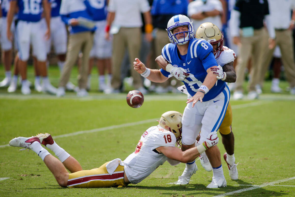 Boston College Eagles defensive back Deon Jones (5) forces Duke Blue Devils quarterback Chase Brice (8) to fumble as Boston College Eagles defensive back Mike Palmer helps to make the tackle in the third quarter at Wallace Wade Stadium. The Boston College Eagles won 26-6.
