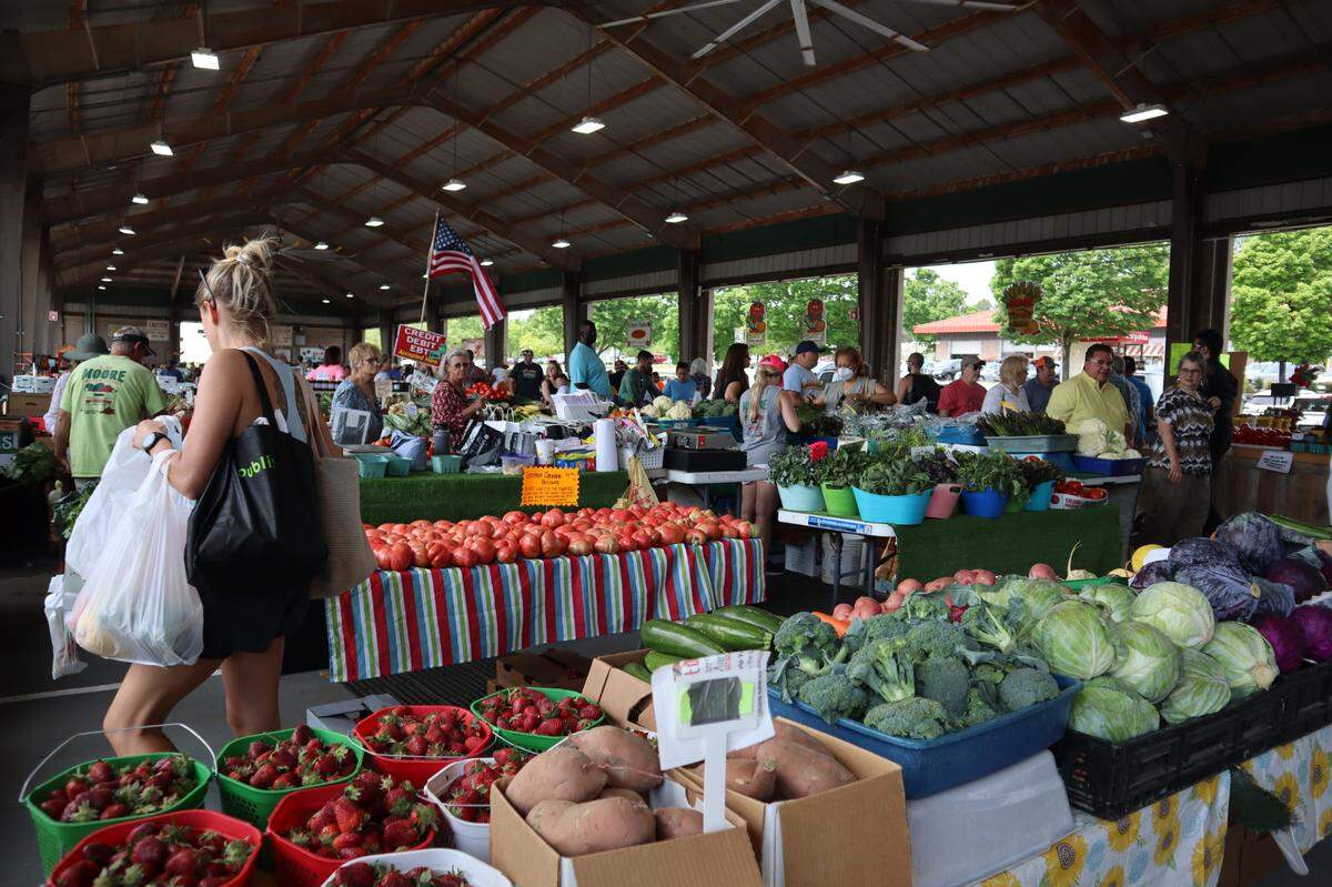 A woman shops for produce at the State Farmers Market in Raleigh, N.C. on May 1, 2022.