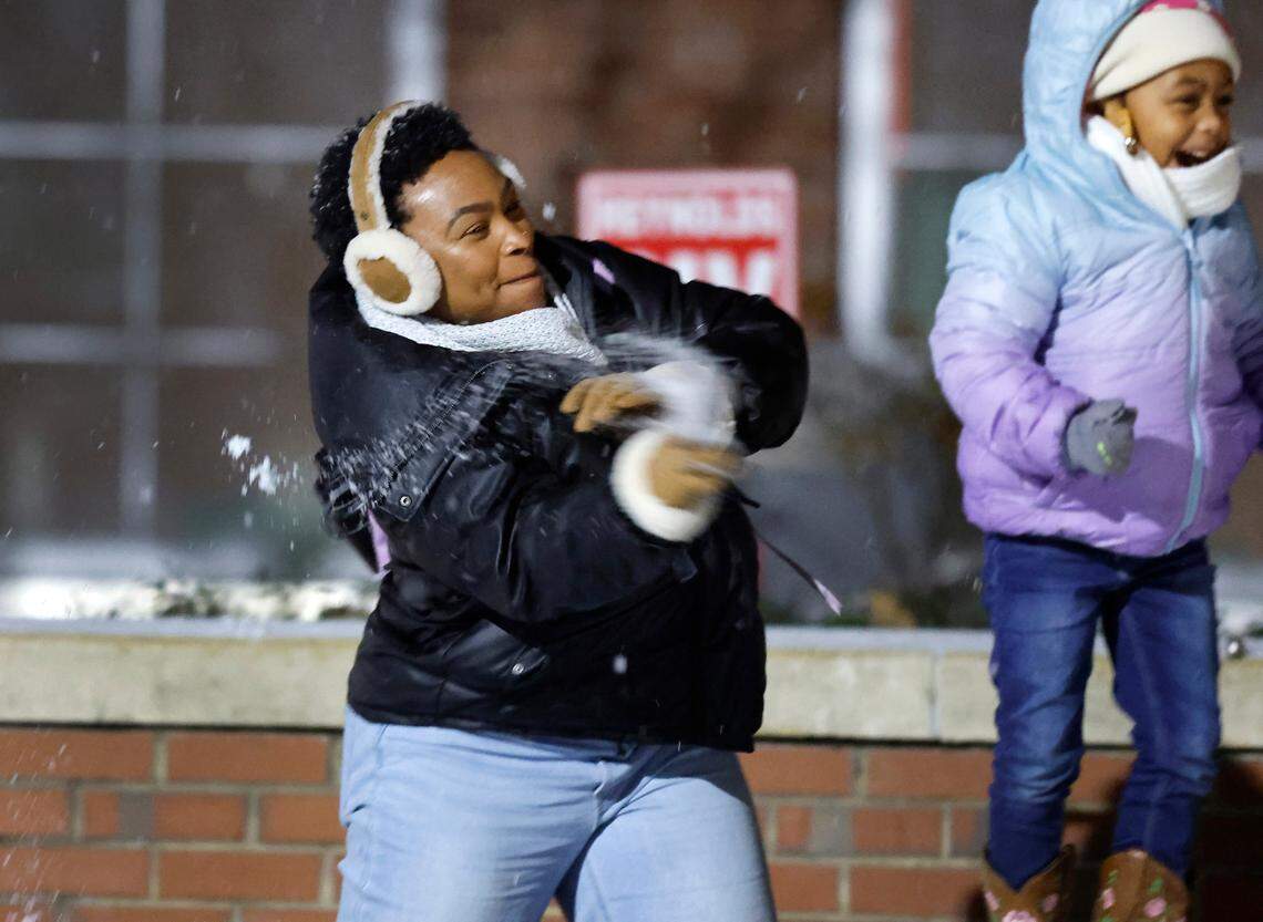 Shelita Richmond throws a snowball at her fiance Brandon Palmer outside Reynolds Coliseum on the campus of N.C. State in Raleigh, N.C., Friday, Jan. 10, 2025.
