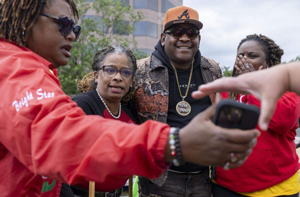 Rapper Petey Pablo, poses for photographs with educators following his performance at the conclusion of the May Day demonstration on the Halifax Mall on Friday, May 1, 2026 in Raleigh, NC.