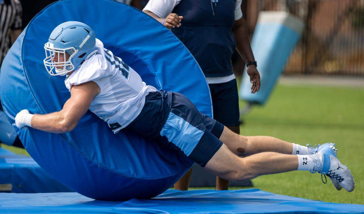 North Carolina defensive lineman Beau Atkinson (12) hits a tackle ring at the Tar Heels’ first practice of the season on Wednesday, August 2, 2023 in Chapel Hill, N.C.