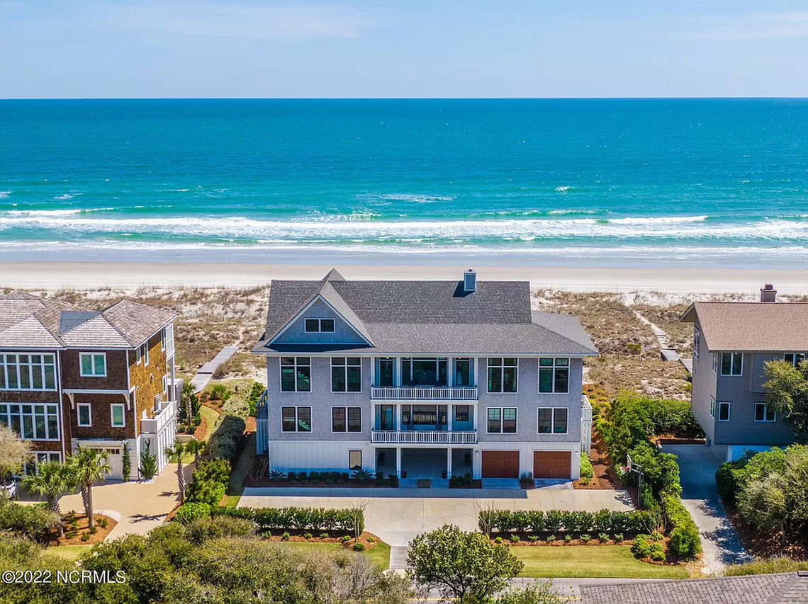 Figure Eight Island is a gated community off the North Carolina coast near Wilmington. A two-lane bridge welcomes residents and visitors to the wealthy enclave where UNC football coach Mack Brown and his wife bought this $10 million home.