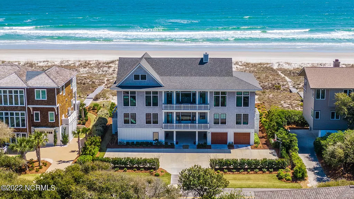 Figure Eight Island is a gated community off the North Carolina coast near Wilmington. A two-lane bridge welcomes residents and visitors to the wealthy enclave where UNC football coach Mack Brown and his wife bought this $10 million home.