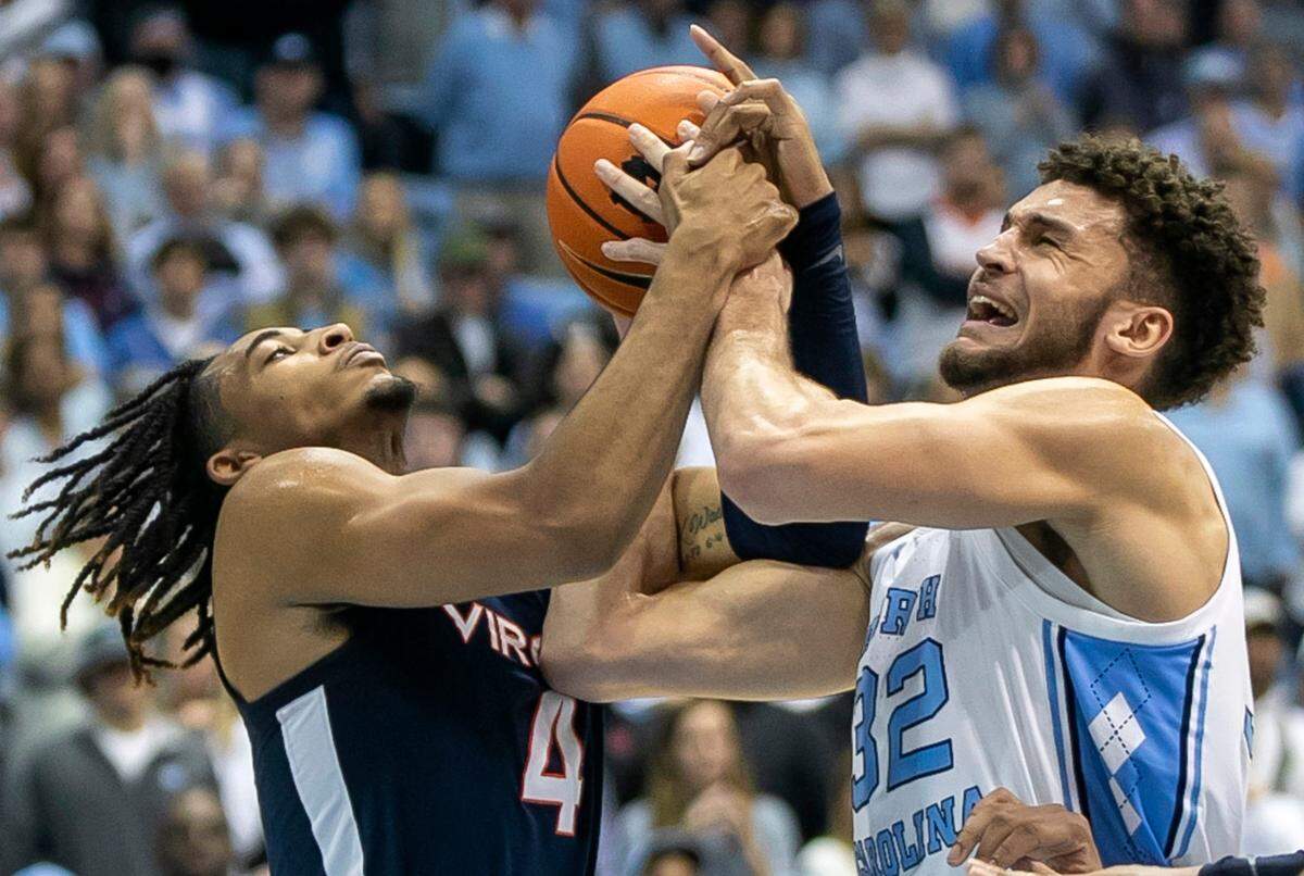 North Carolina’s Pete Nance (32) battles for a defensive rebound with Virginia’s Armaan Franklin (4) in the second half on Saturday, February 25, 2023 at the Smith Center in Chapel Hill, N.C.